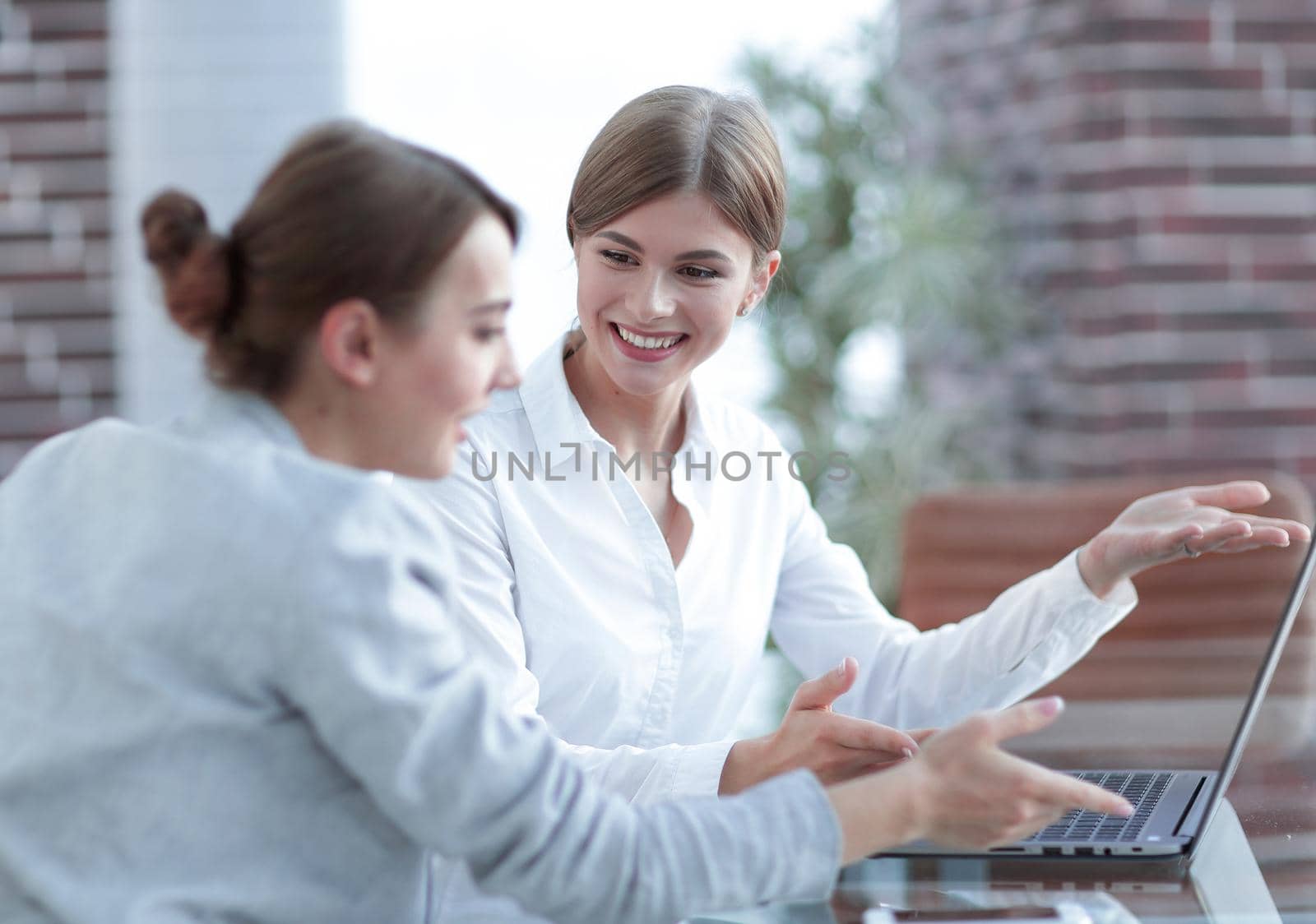 members of the business team working with laptop and discussing new ideas.