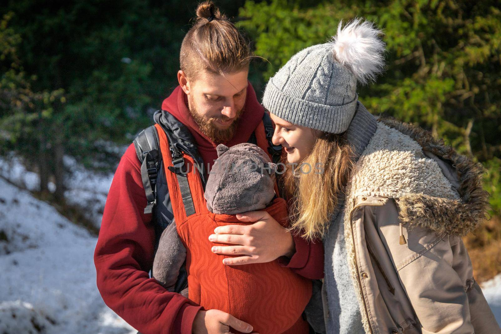 Babywearing young family winter hiking outdoor lifestyle.