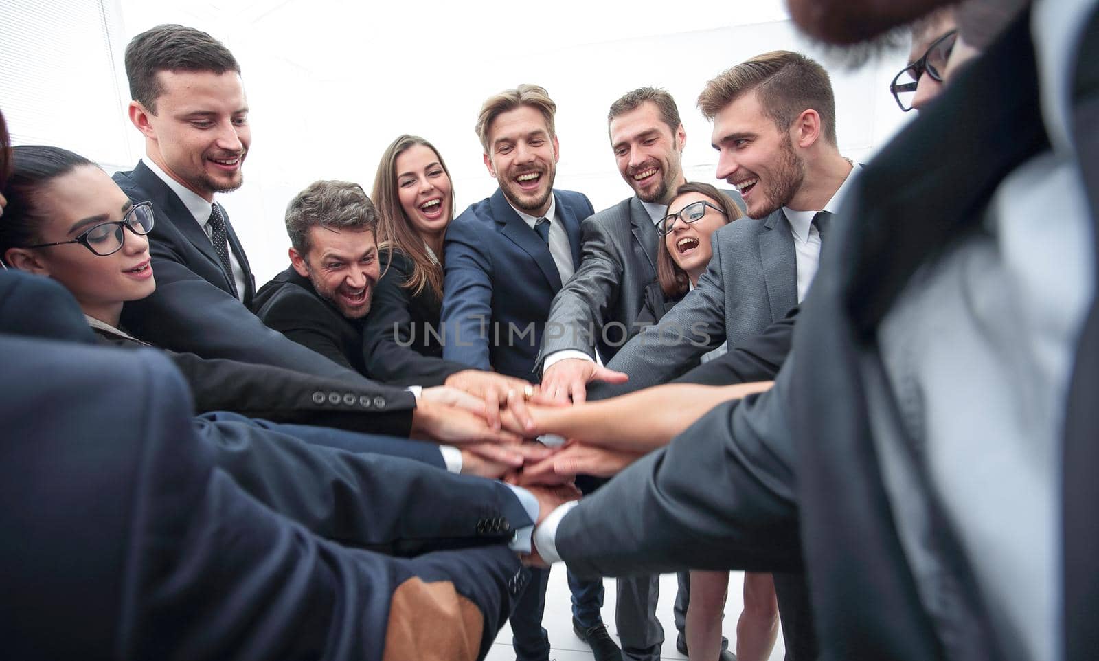 large group of business people standing with folded hands together by asdf