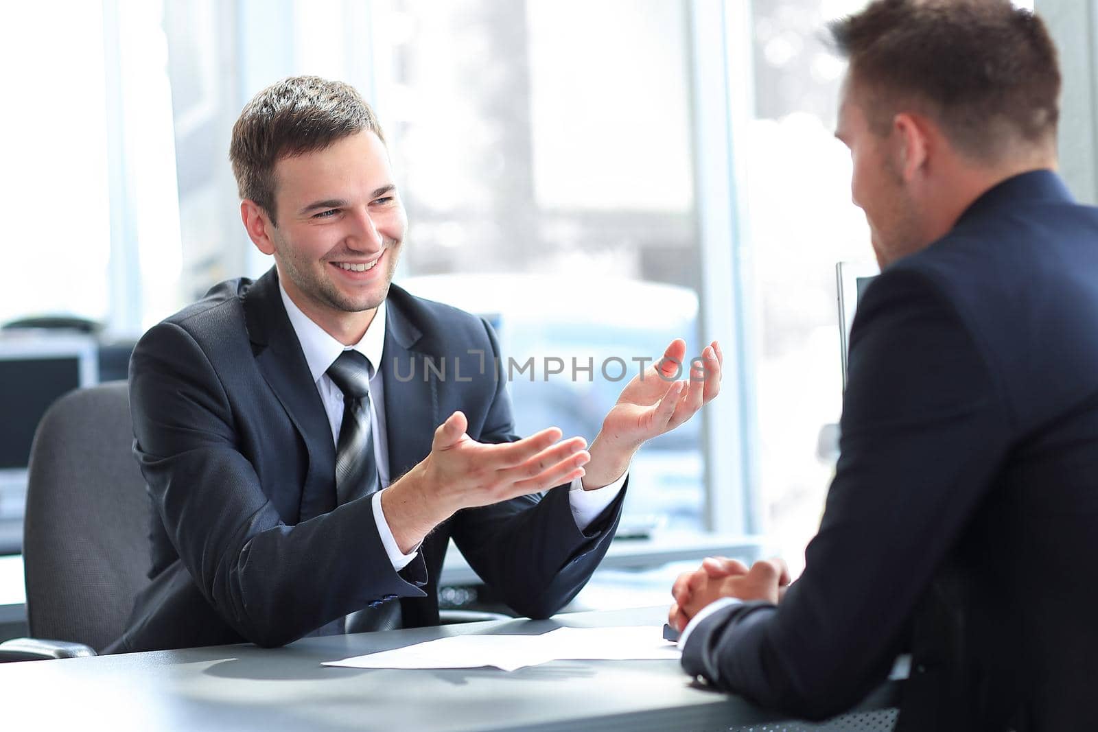 business partners talking while sitting at your Desk . photo with copy space