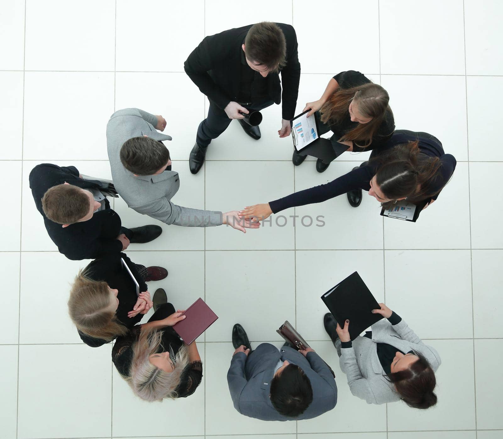 top view. financial partners confirming the transaction with a handshake. business concept