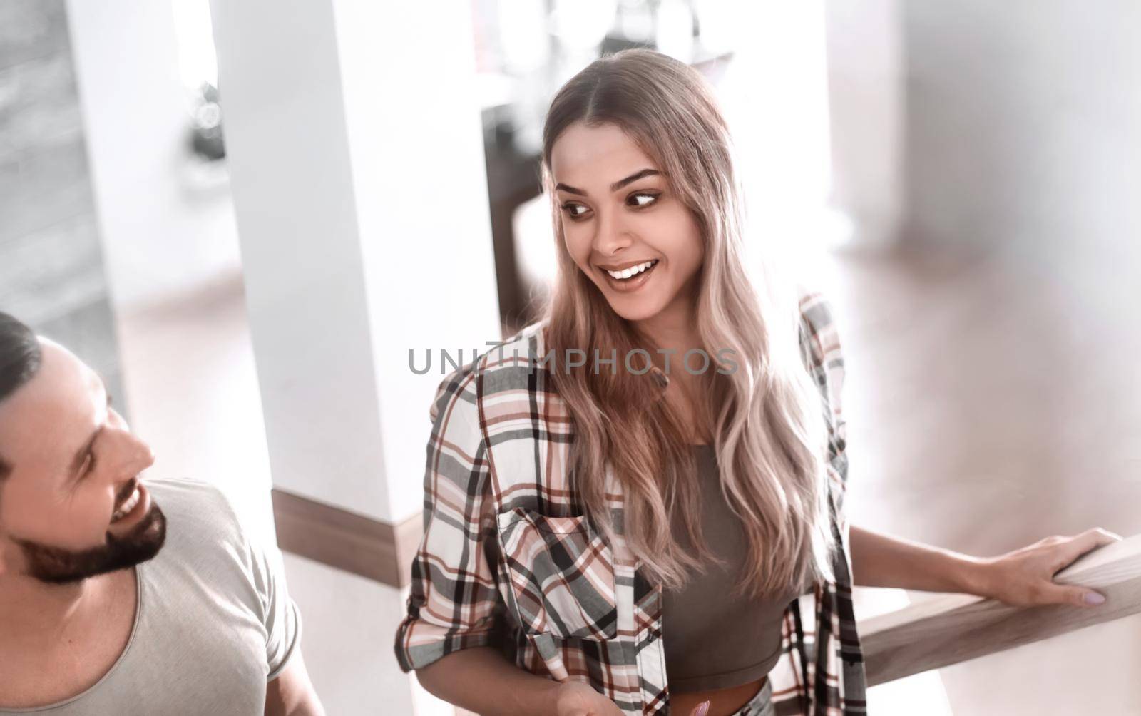 young couple climbed the stairs to their new apartment. photo with copy space