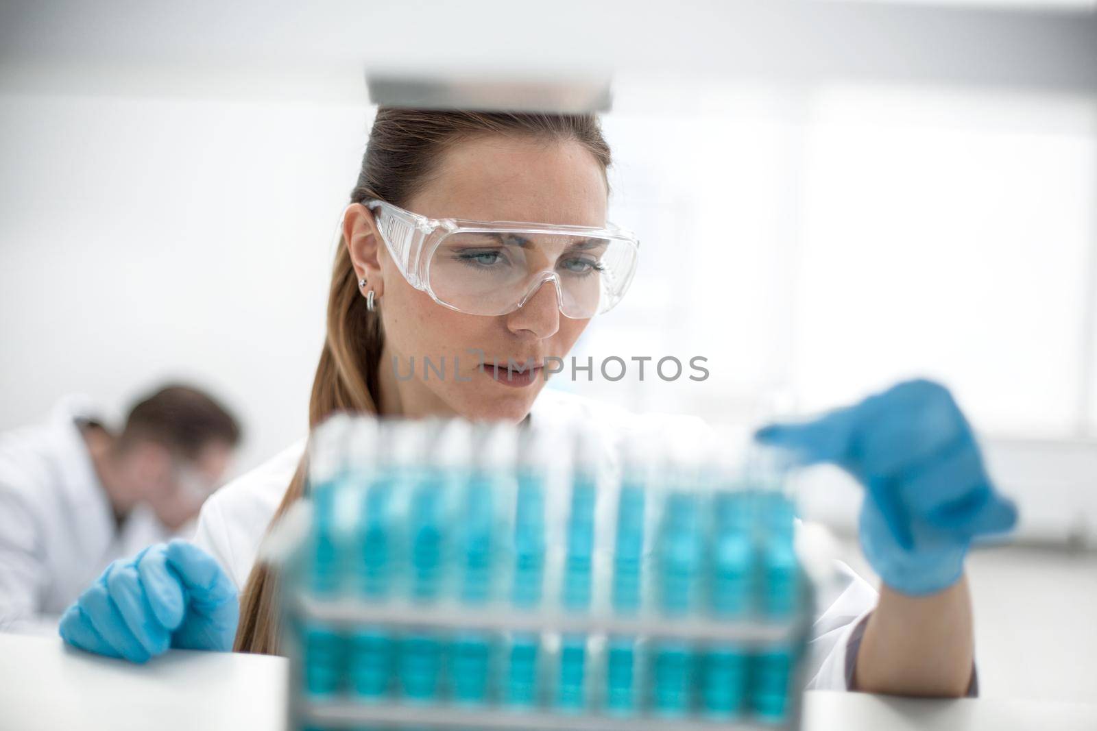 Test tube in scientist hand in laboratory by asdf