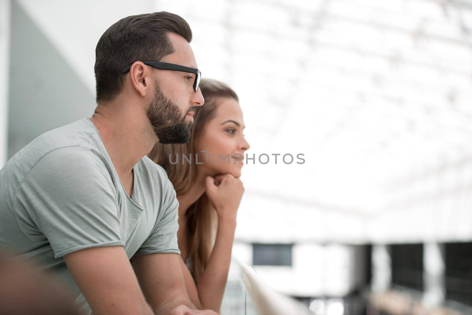 side view.young couple standing on the balcony of the hotel.close up.photo with copy space