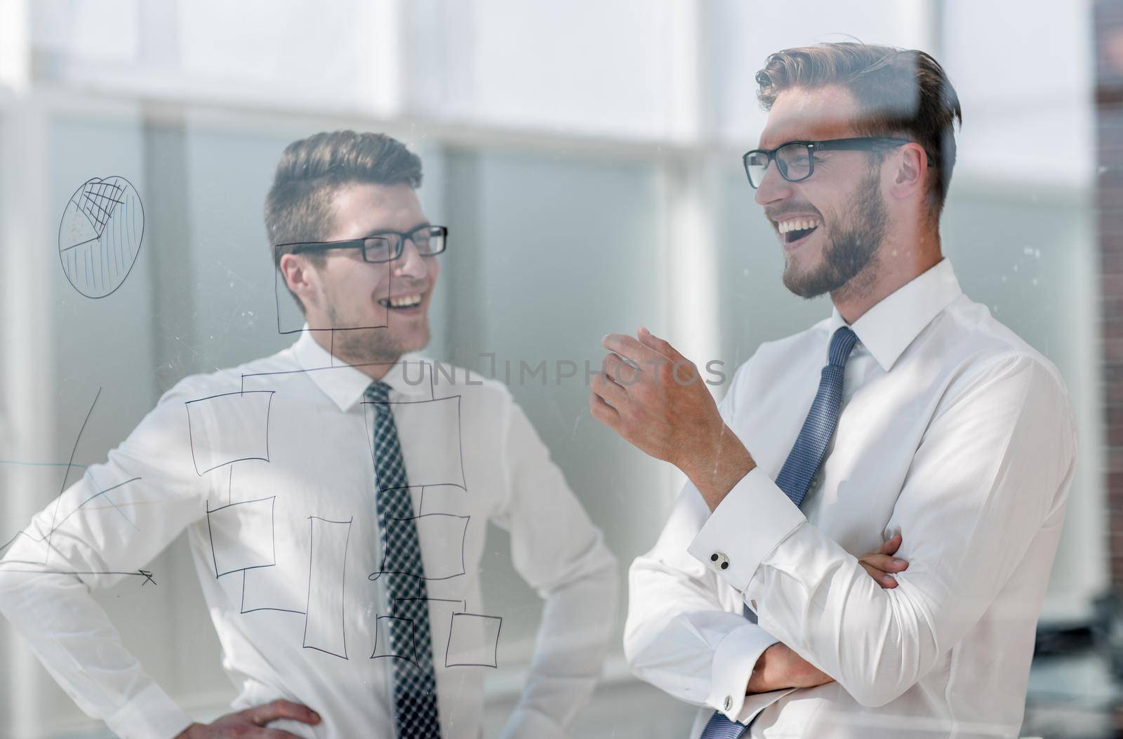 close up.two employees talking standing in the office by asdf