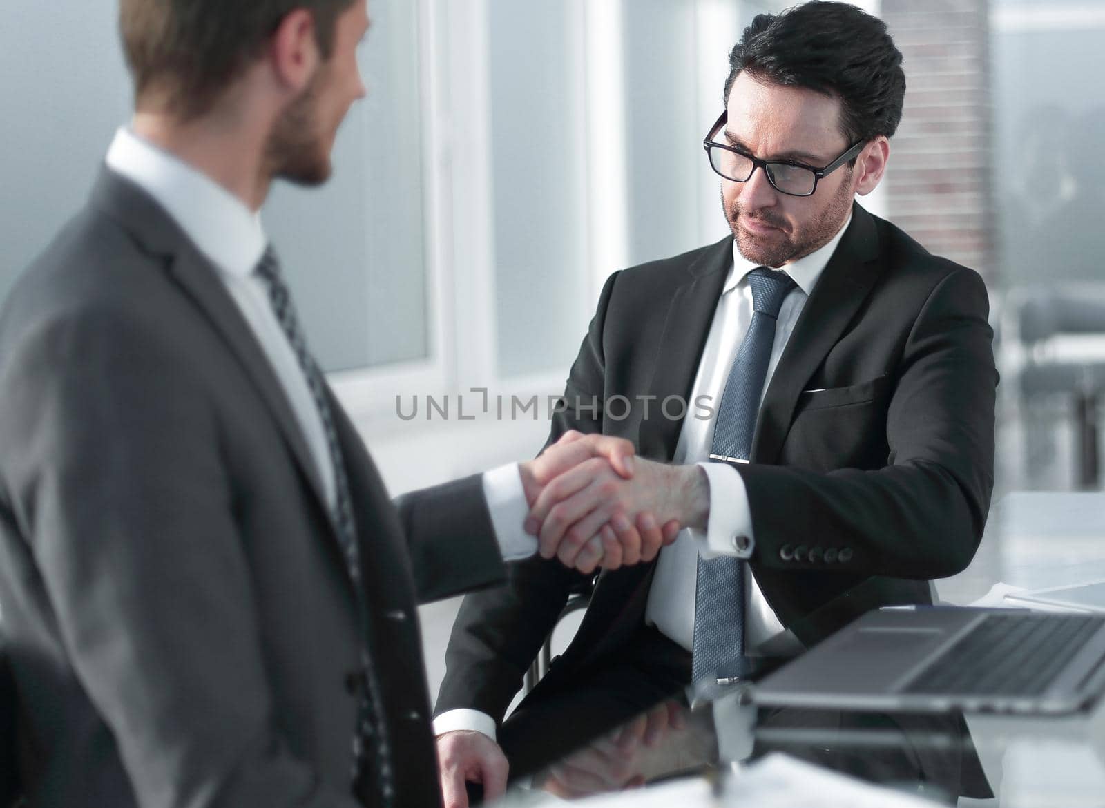 business people shaking hands over a Desk by asdf