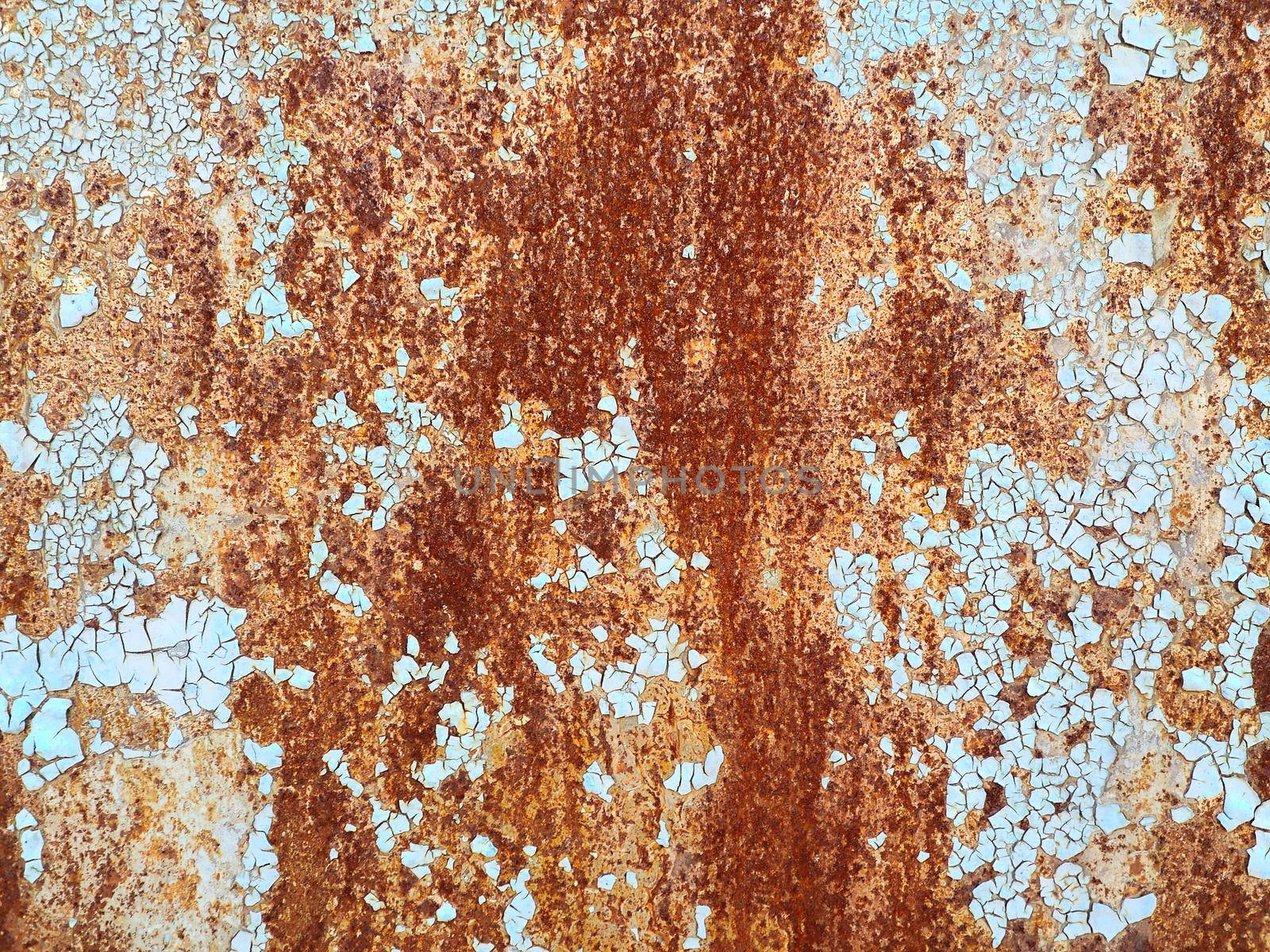 Corroded metal background. Rusted white painted metal wall. Rusty metal background with streaks of rust. Rust stains. The metal surface rusted spots. Rystycorrosion.