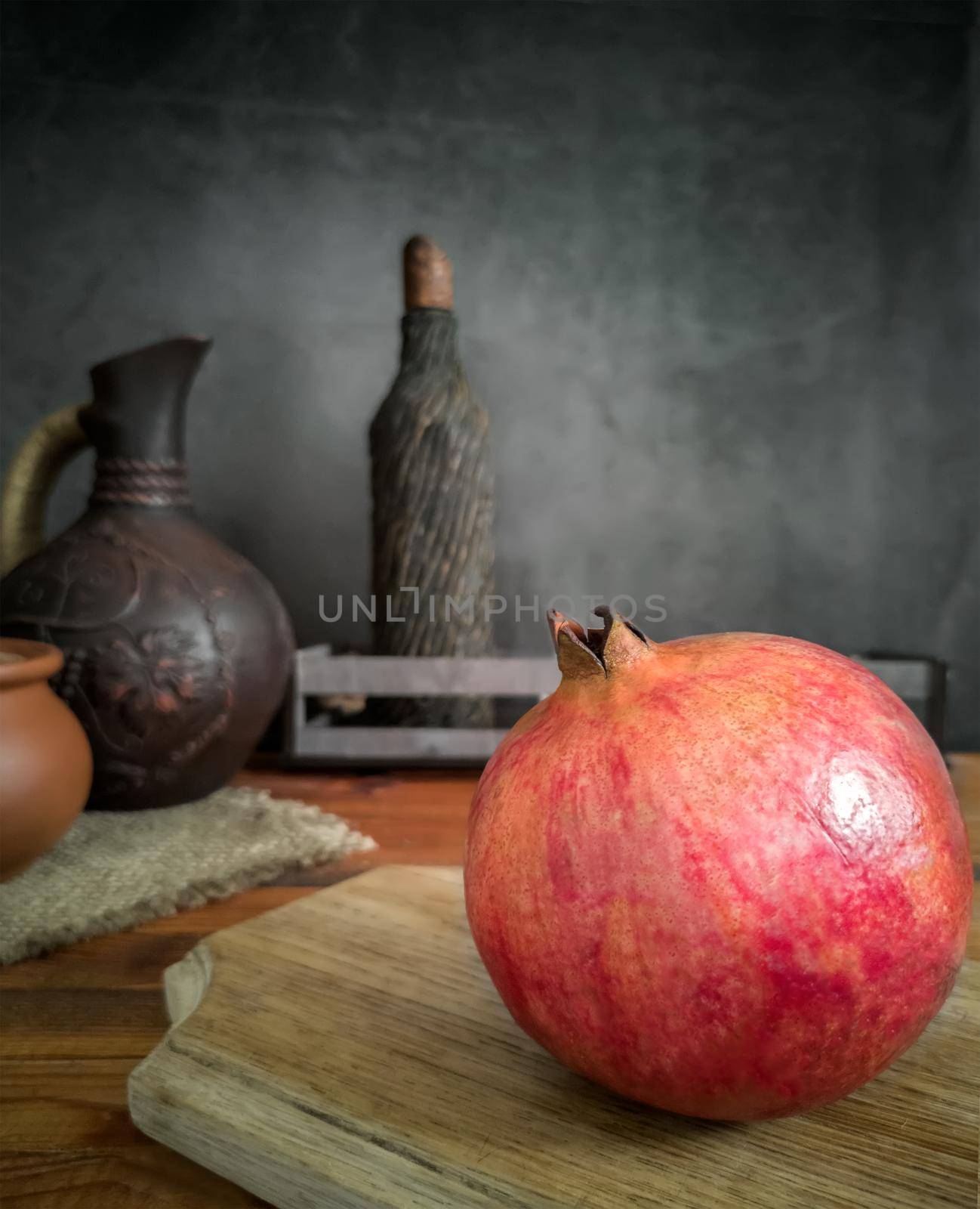 Ripe juicy fruit pomegranate on the table by georgina198