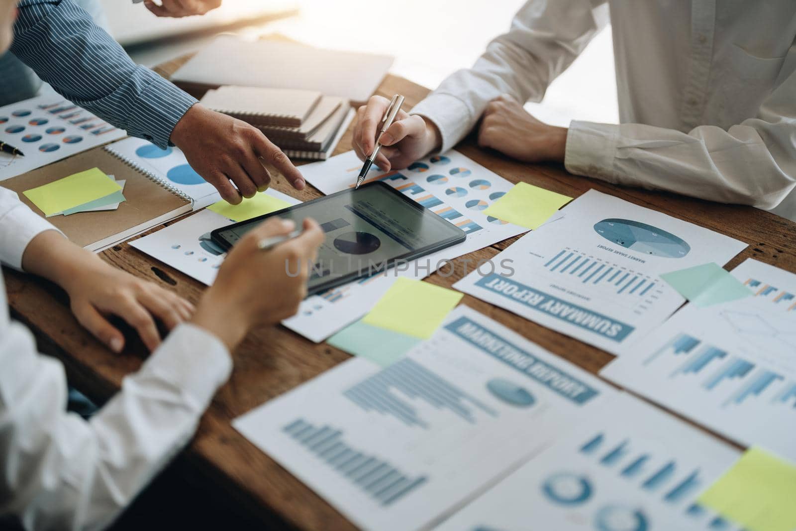 Business People Meeting using laptop computer,calculator,notebook,stock market chart paper for analysis Plans to improve quality next month. Conference Discussion Corporate Concept.