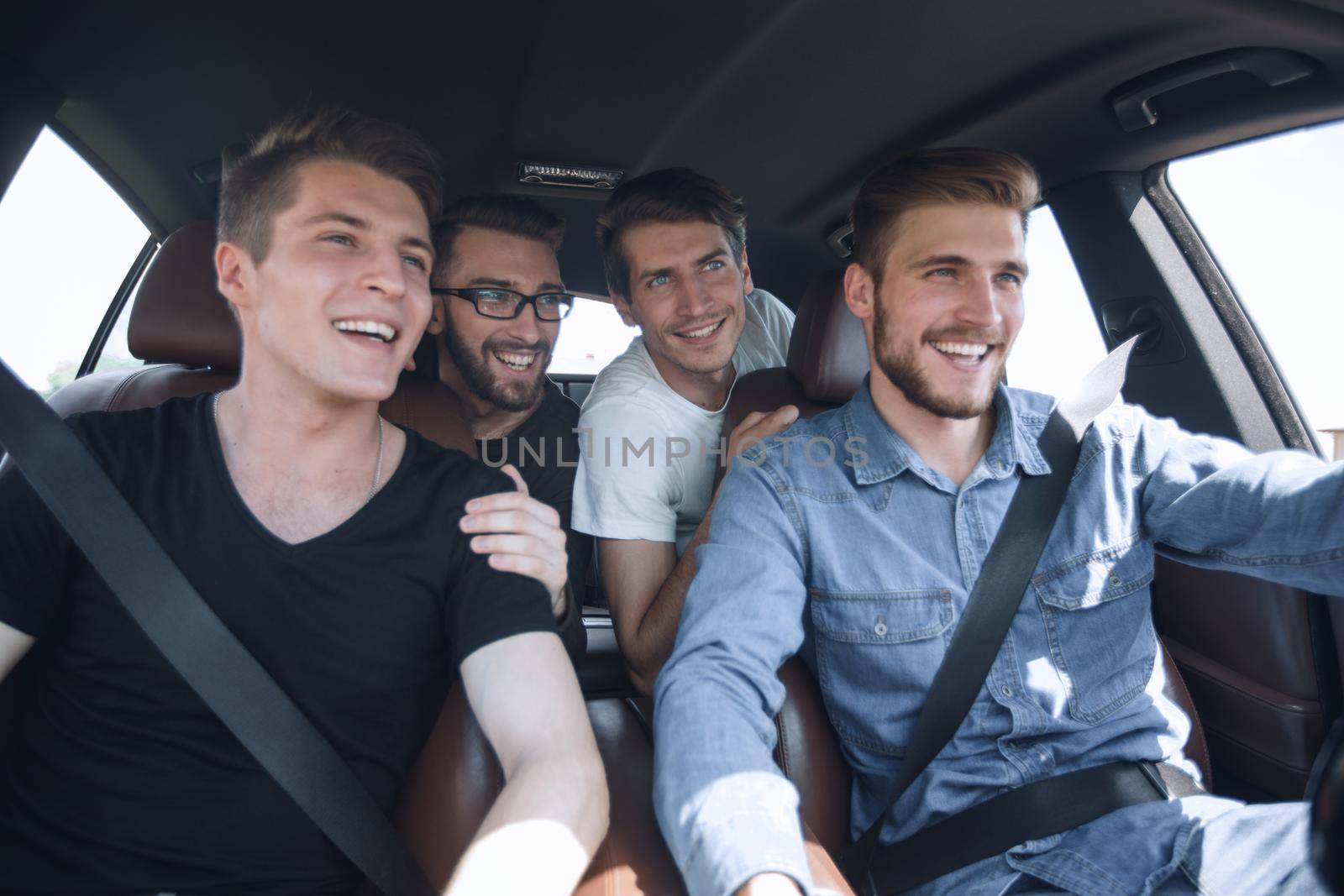 close up. three friends travel in a car by asdf