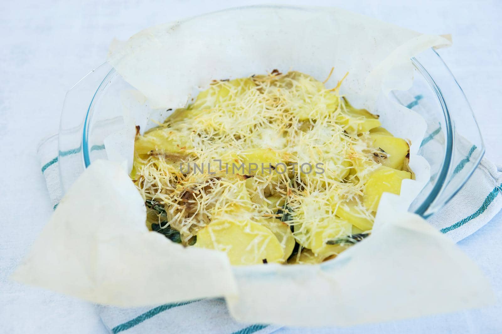 Potato casserole with cheese and herbs. Homemade food, cooking at home. Healthy food.