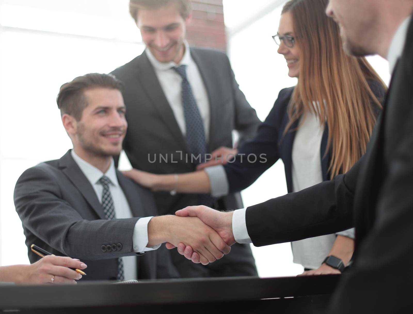 Handshake between employees after the meeting by asdf