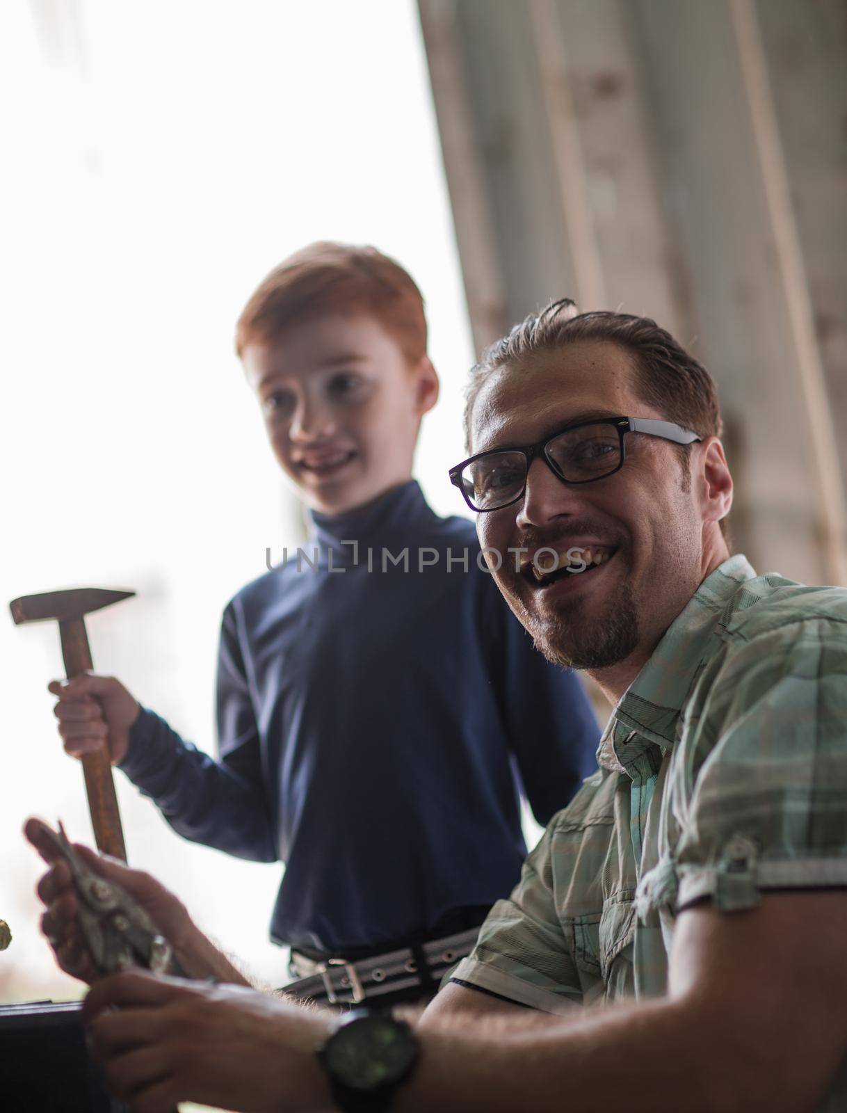 portrait of father and son in the home garage by asdf