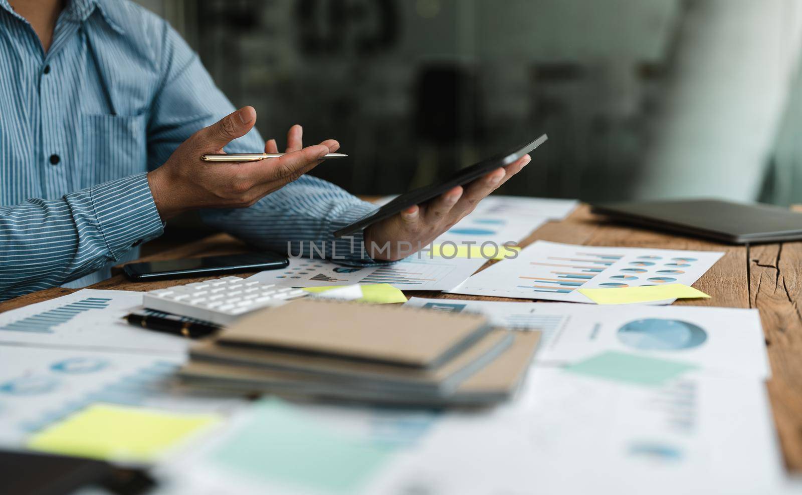 Businessman accountant or financial expert analyze business report graph and finance chart at corporate office. Concept of finance economy, banking business and stock market research.