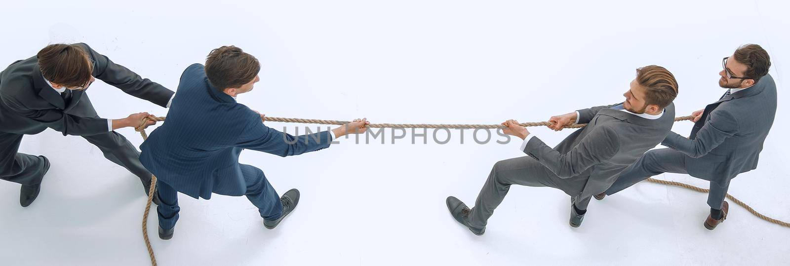 top view.a tug of war between business teams .isolated on white background