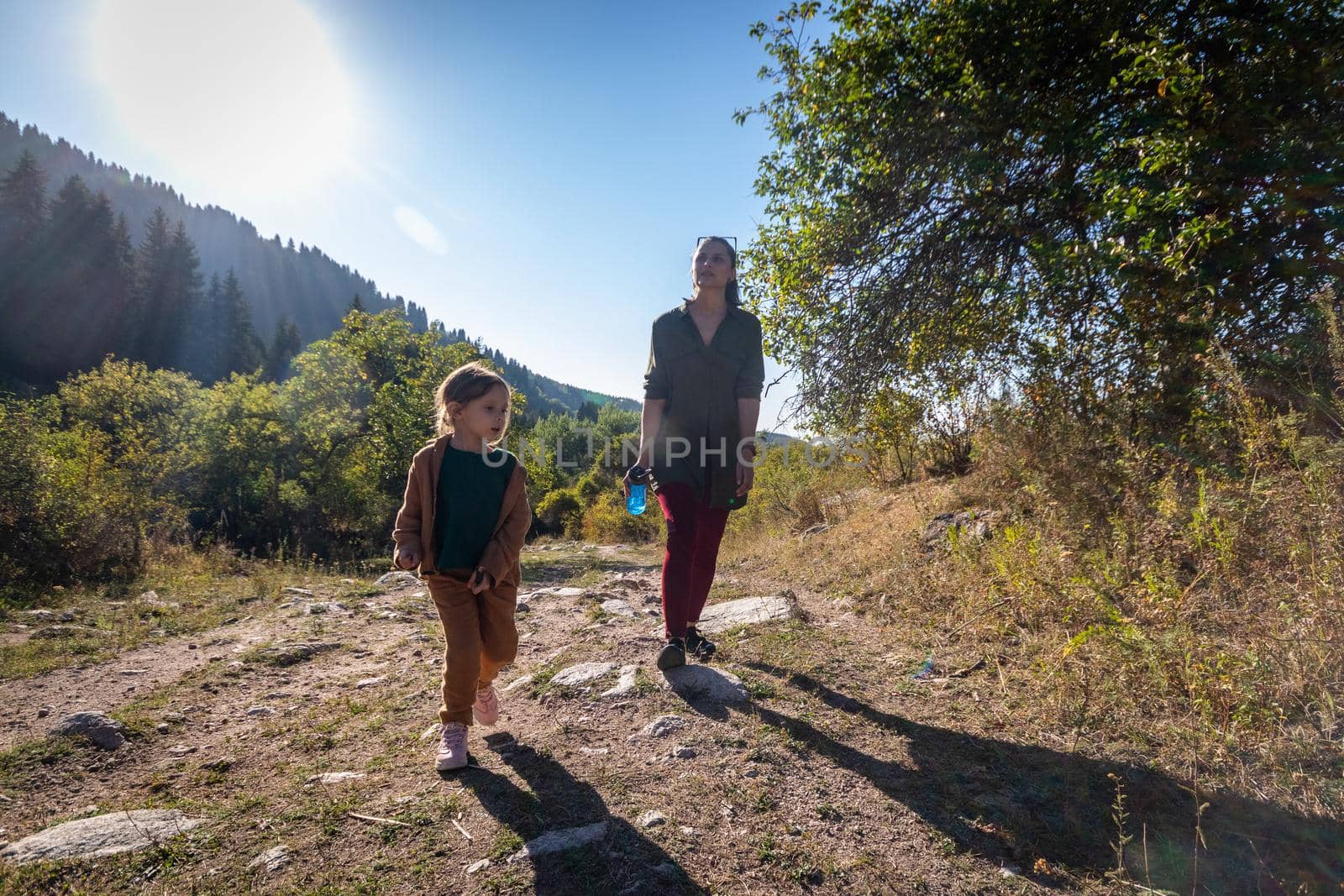 Woman with her daughter 5 years old on a hike in the mountains by Rom4ek