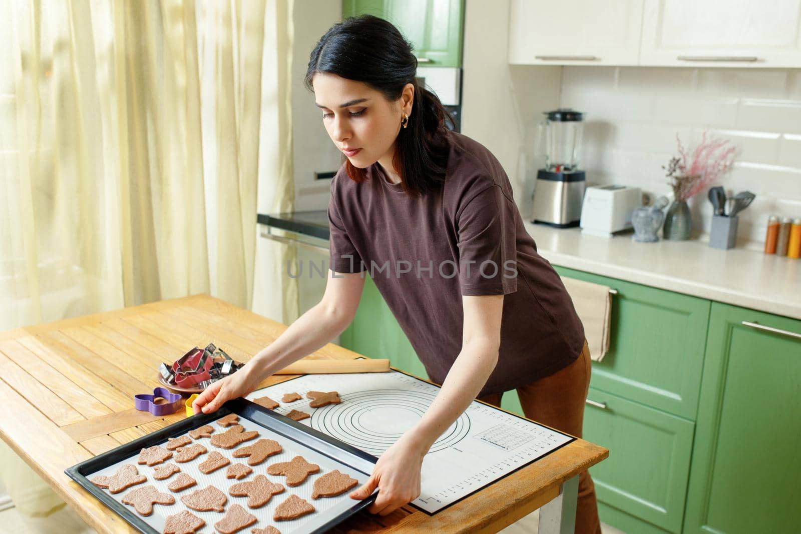 Young beautiful woman preparing dessert for breakfast in the home kitchen in the early morning.