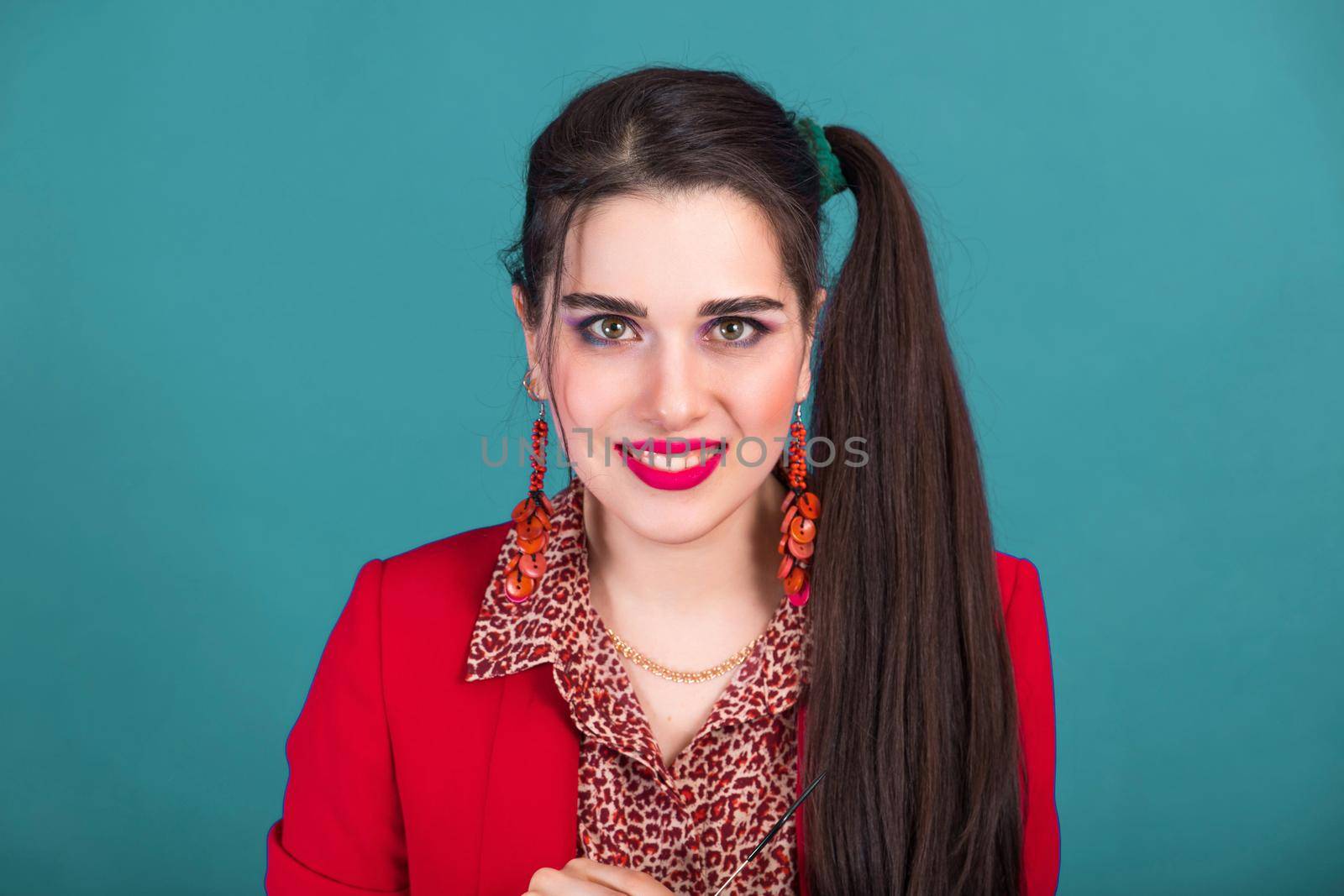 Bright colorful makeup in the style of 80s and 90s on a beautiful young woman.