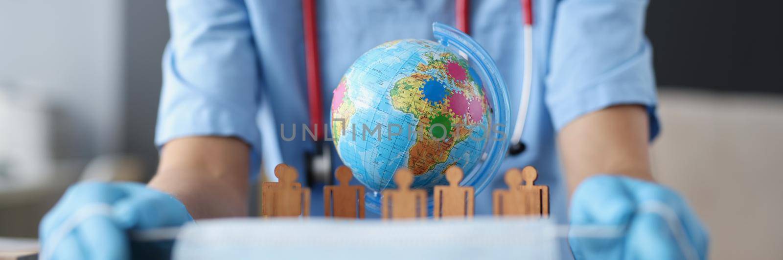 Close-up of female doctor hands holding sterile mask by kuprevich