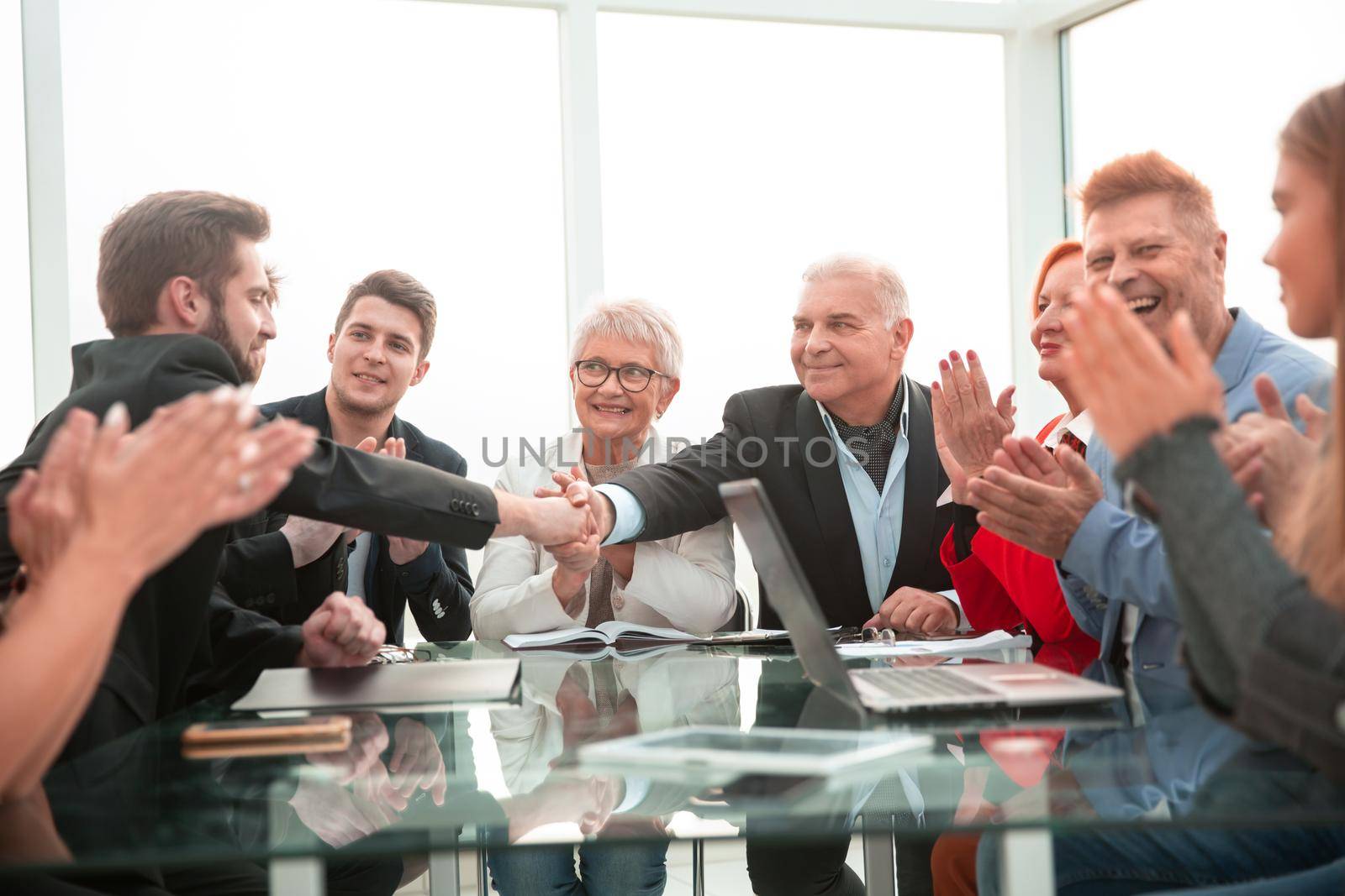 businessmen shaking hands in a meeting at office by asdf