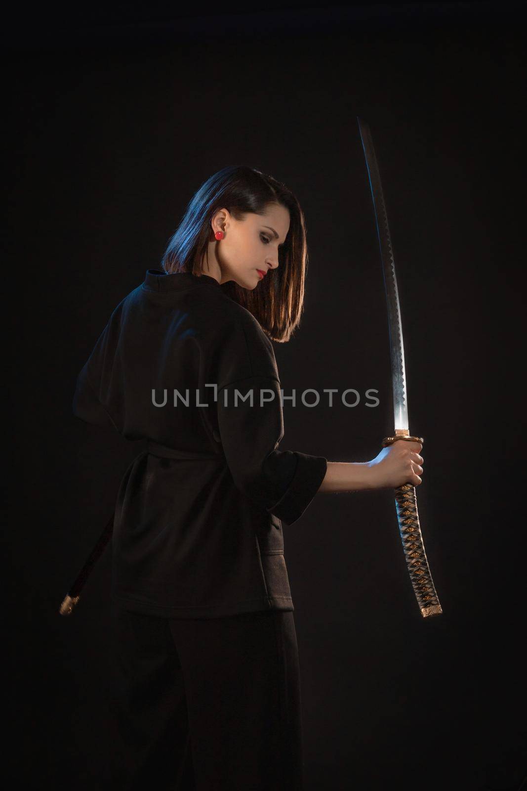 Mysterious young beautiful woman with sharp blade in asian style.