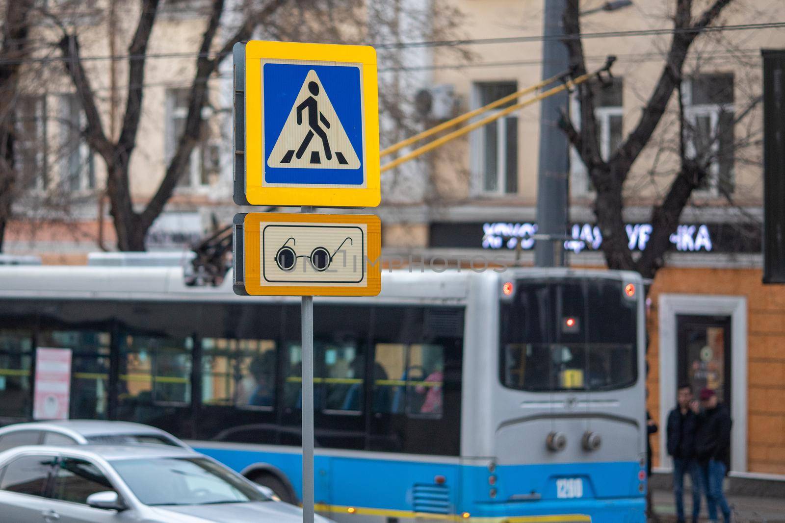 Pedestrian crossing sign for the blind on a busy Almaty street. Almaty, Kazakhstan - March 21, 2021