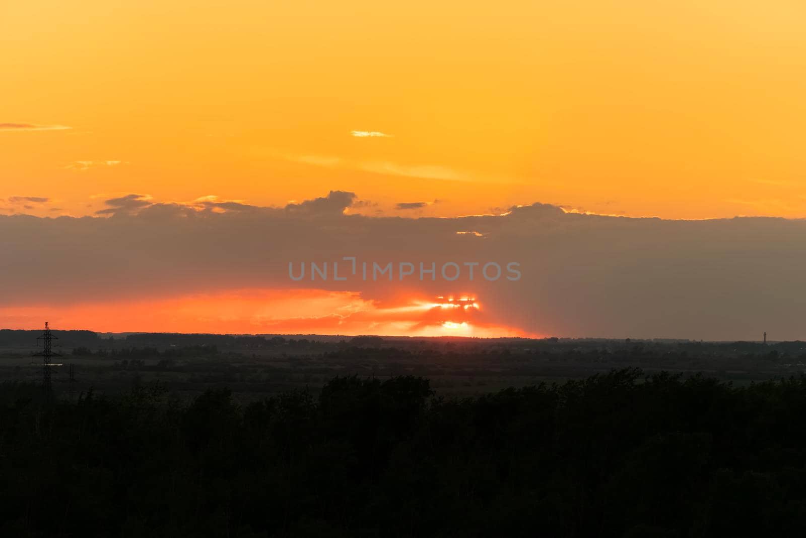 The heavenly light of the sun.Dramatic evening sky with clouds and rays of the sun.Sunlight at evening sunset or morning sunrise.Panoramic view of clouds in motion.Golden rays of the sun and clouds by YevgeniySam