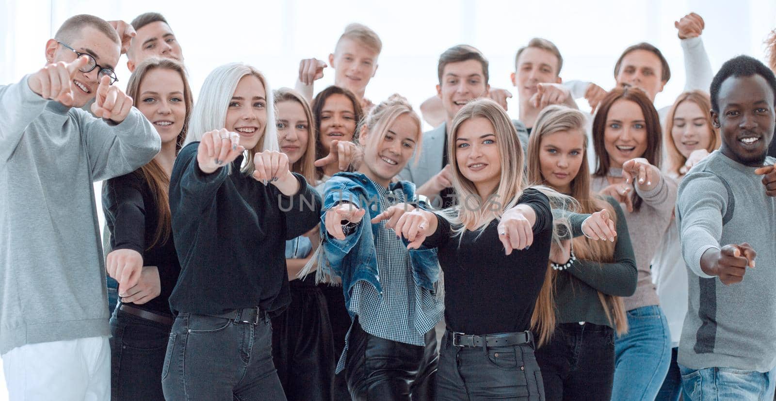 group of confident young people pointing at you. isolated on white background