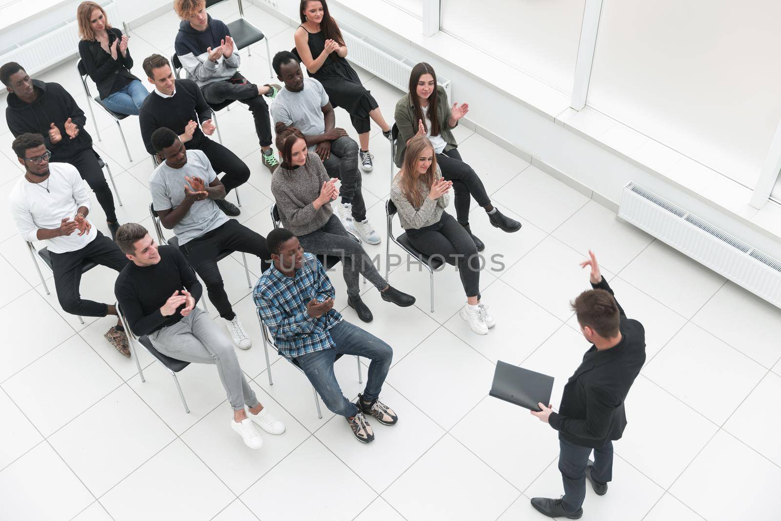 Speaker Giving a Talk at Business Meeting. Audience in the conference hall. Business and Entrepreneurship. Copy space on white board.