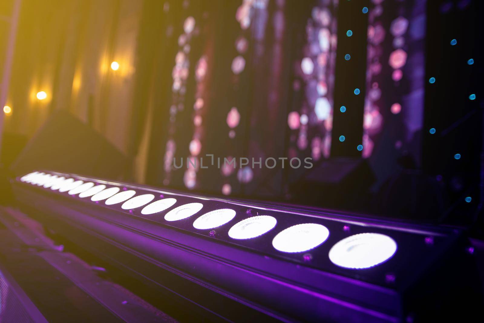 Professional lighting equipment lies on the floor of the stage in the concert hall.