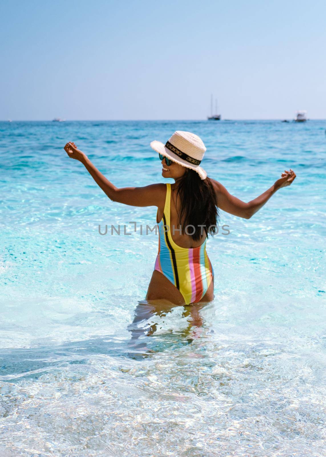 Golfo di Orosei Sardina, Asian women on the beach Sardinia Italy, a young girl on vacation Sardinia Italy, woman playing in the ocean with crystal clear blue water,