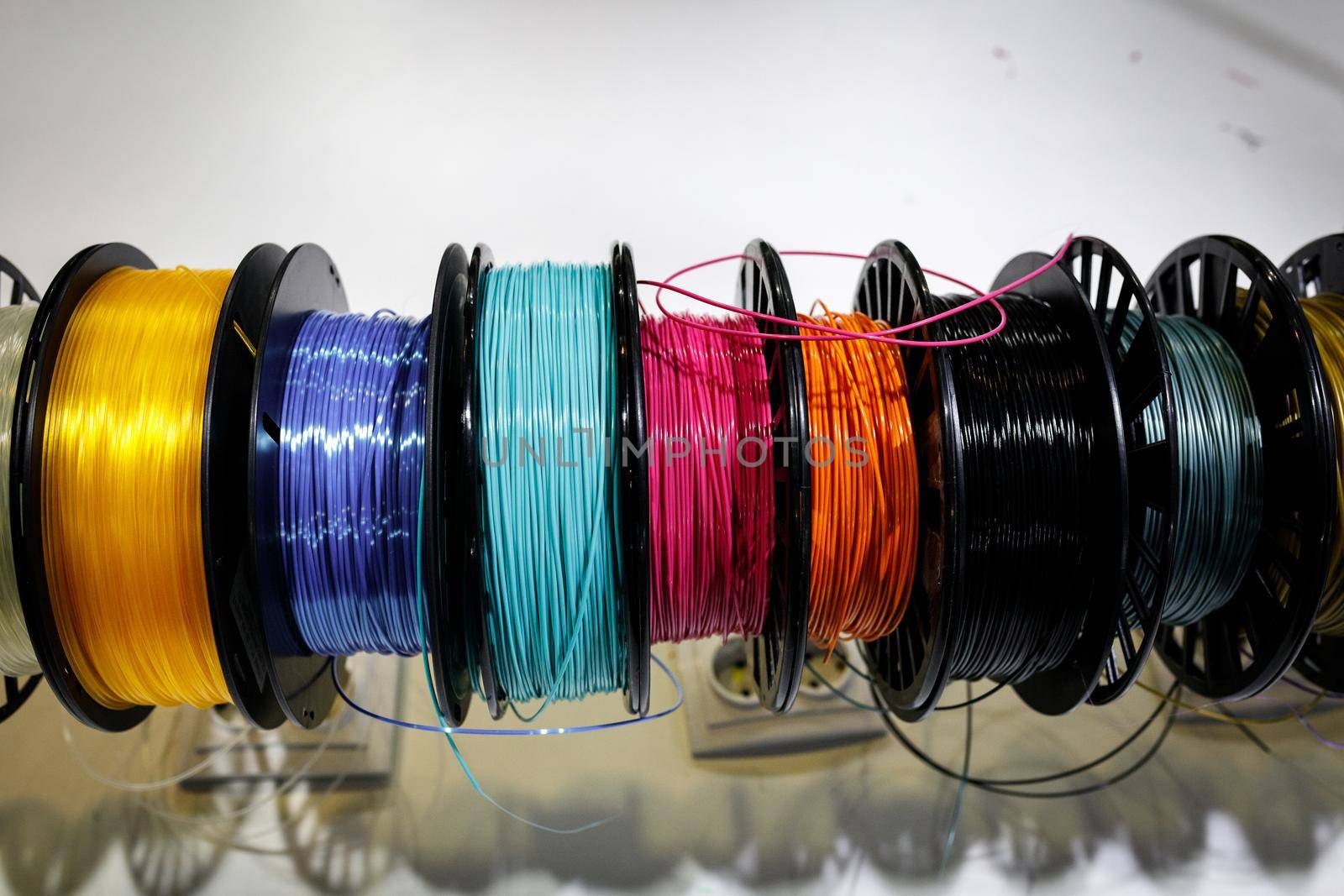 Top view of Colorful plastic PLA and ABS spools with thread for printing on a 3D pen.