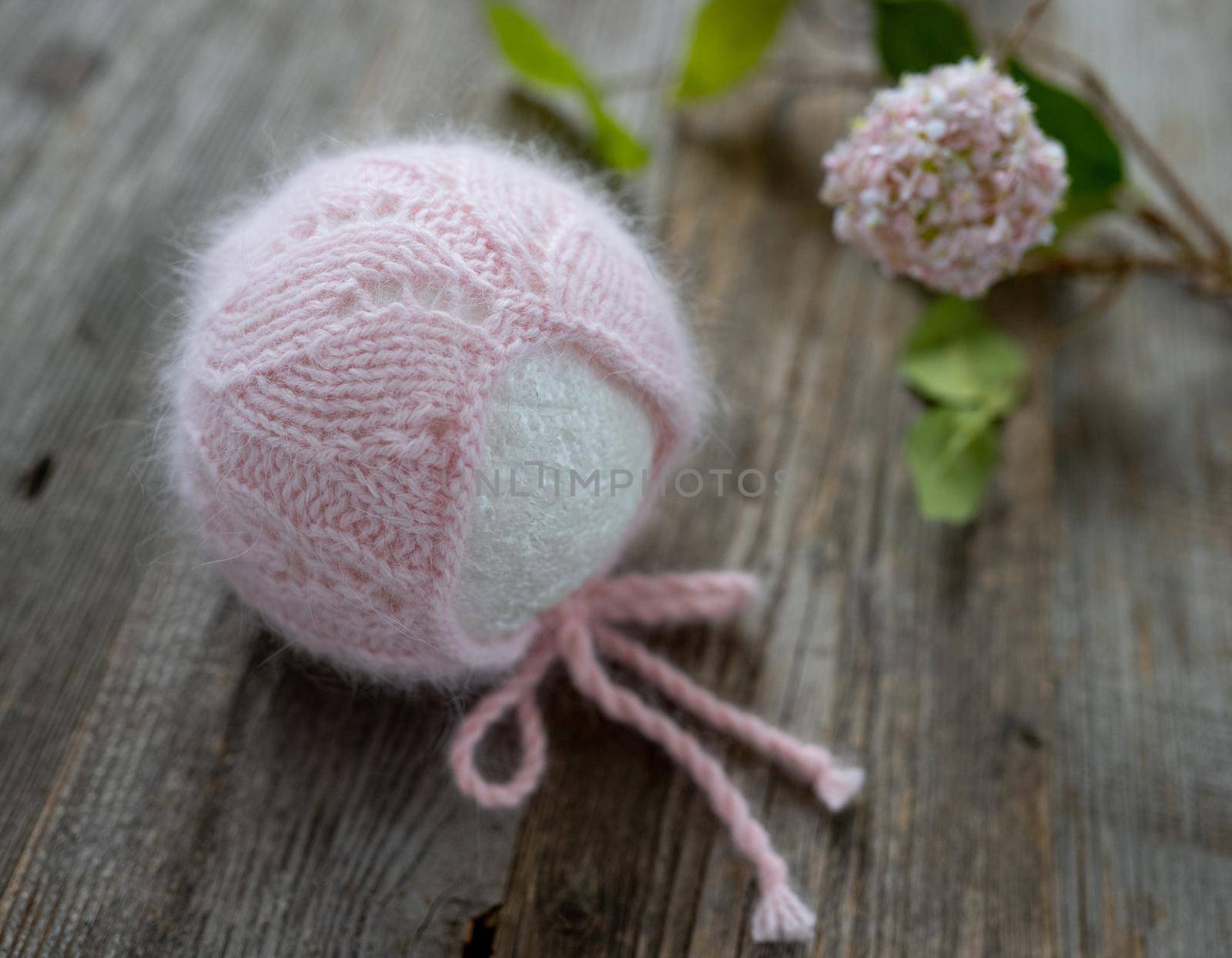 tender knitted for newborn on wooden background