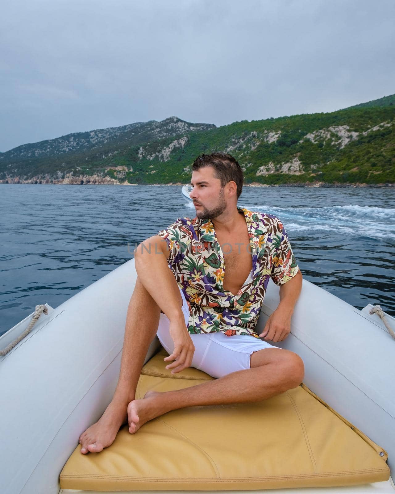 Golfo di Orosei Sardina, Men on the beach chilling in speed boat Sardinia Italy, young guy on vacation Sardinia Italy, man playing in the ocean with crystal clear blue water, by fokkebok