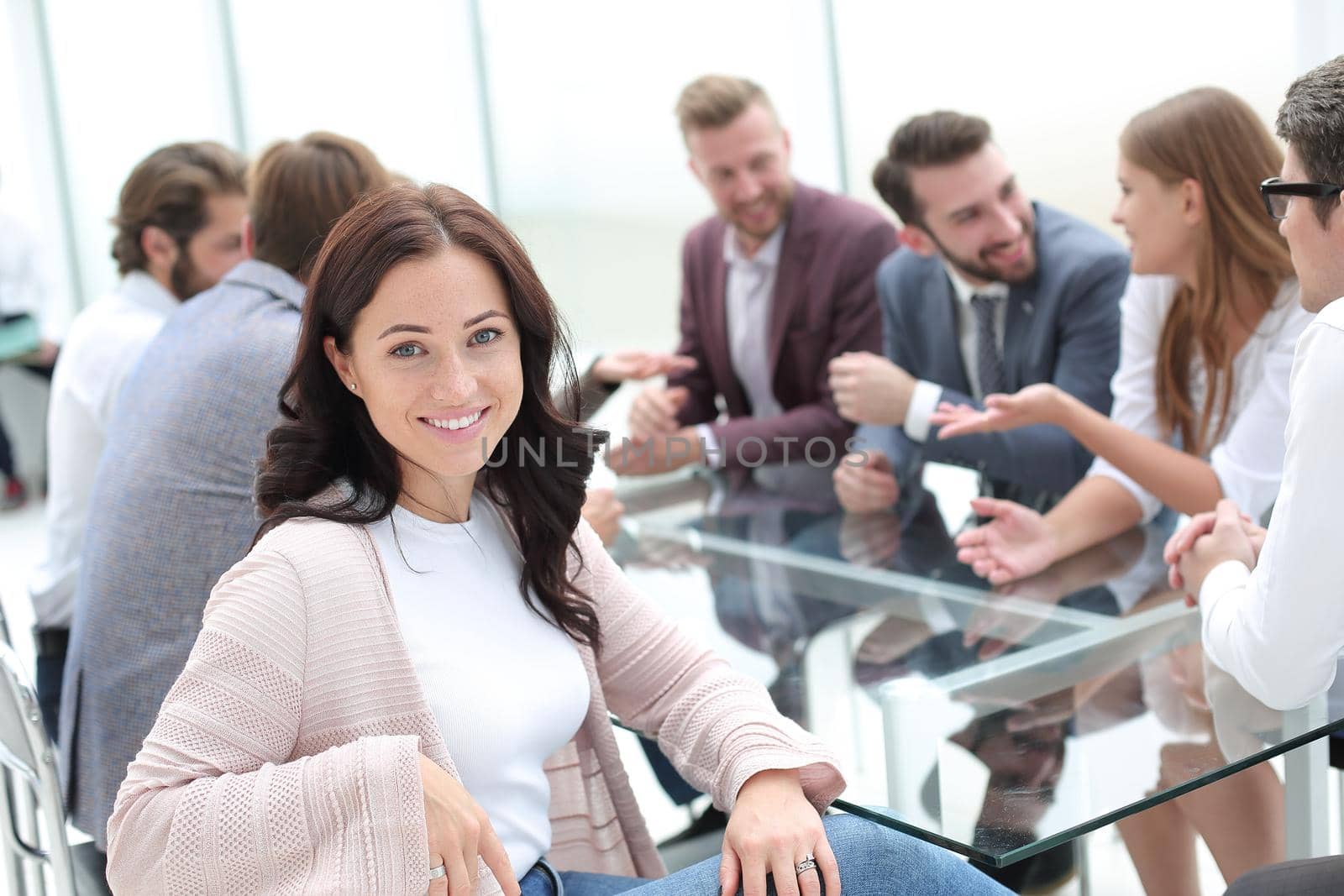 young business woman sitting at corporate business team meeting . by asdf