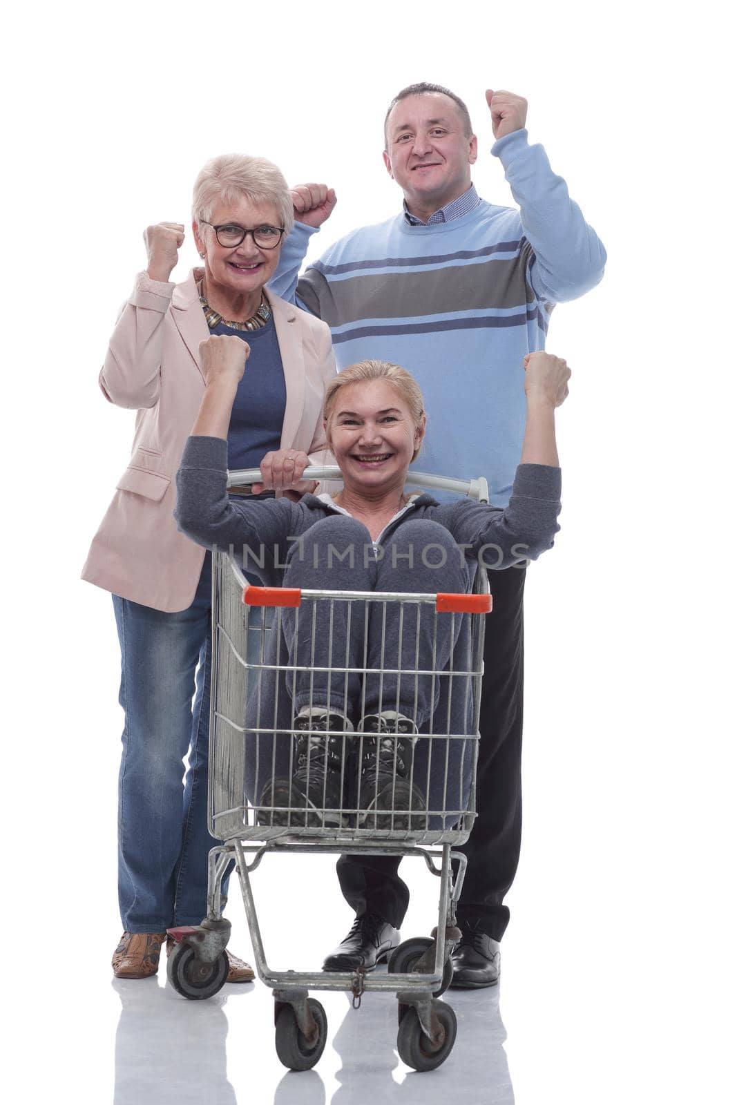 in full growth. a group of cheerful shoppers with a shopping cart . isolated on a white background