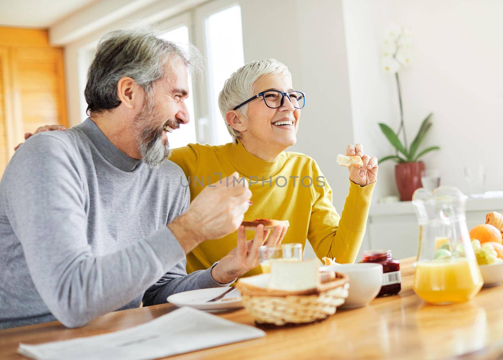 senior couple having fun during a breakfast at home