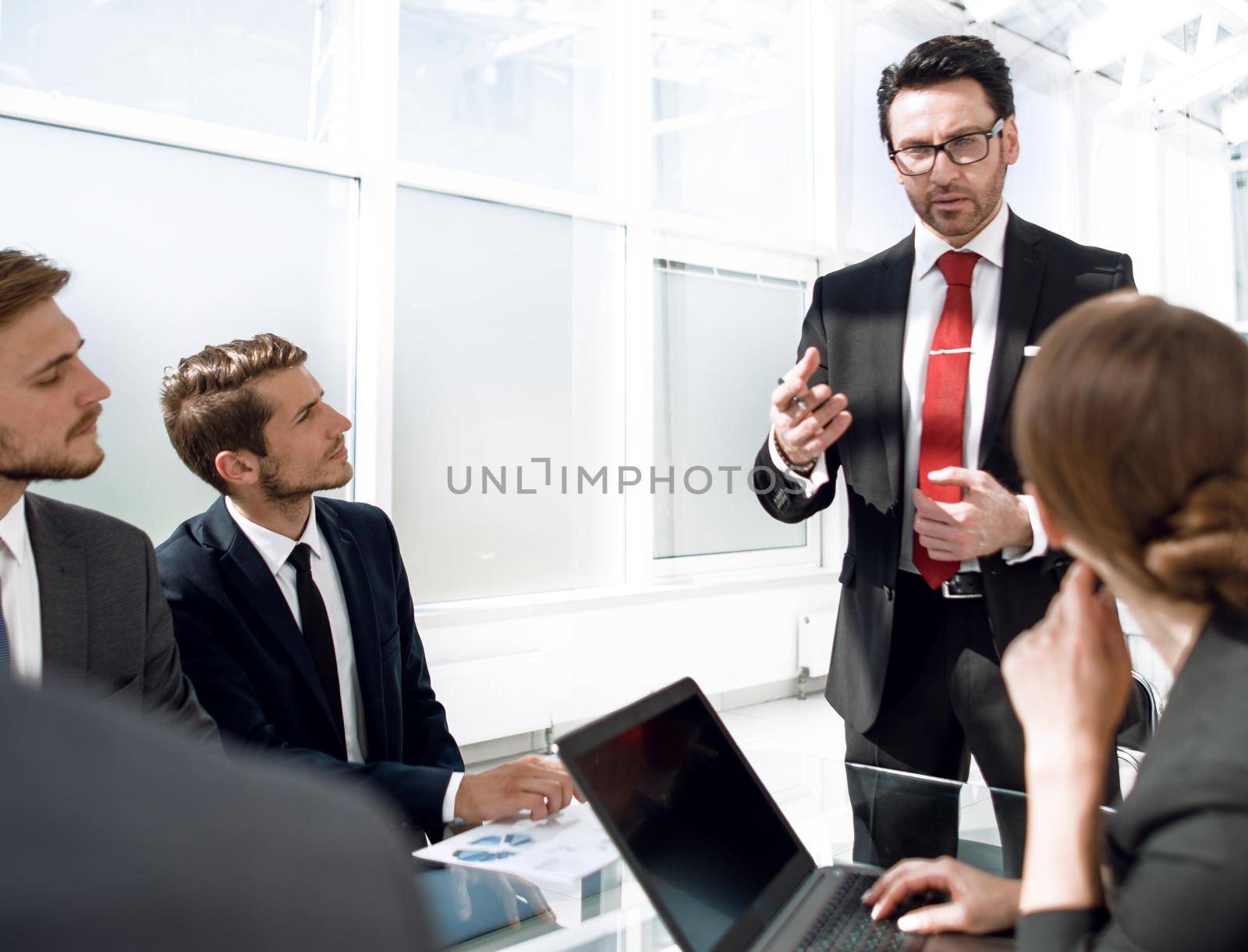 businessman holds a briefing with the business team by asdf