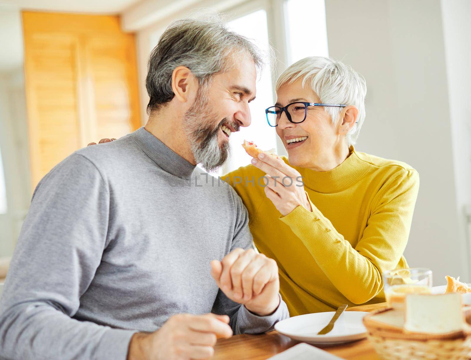 senior couple having fun during a breakfast at home