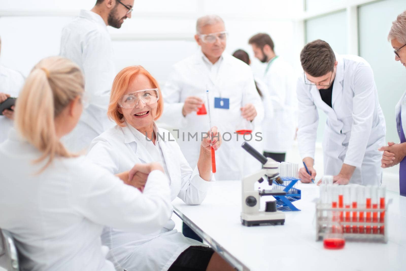 group of doctors and scientists work in the laboratory. by asdf