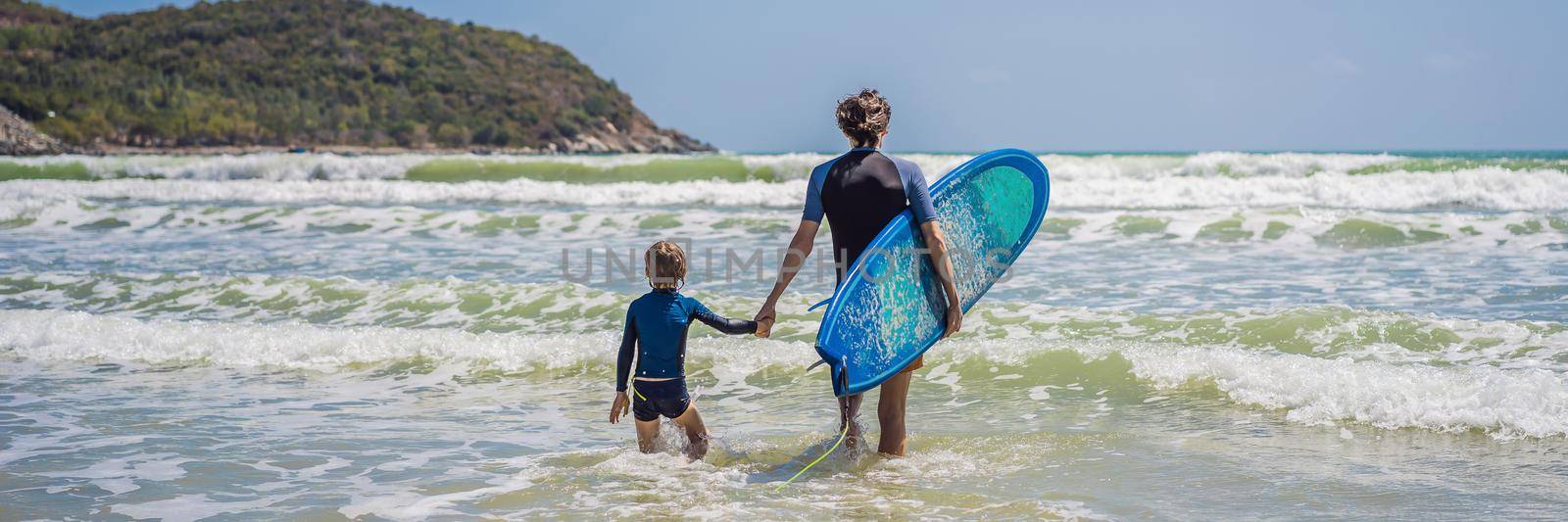 BANNER, LONG FORMAT Father or instructor teaching his son how to surf in the sea on vacation or holiday. Travel and sports with children concept. Surfing lesson for kids.