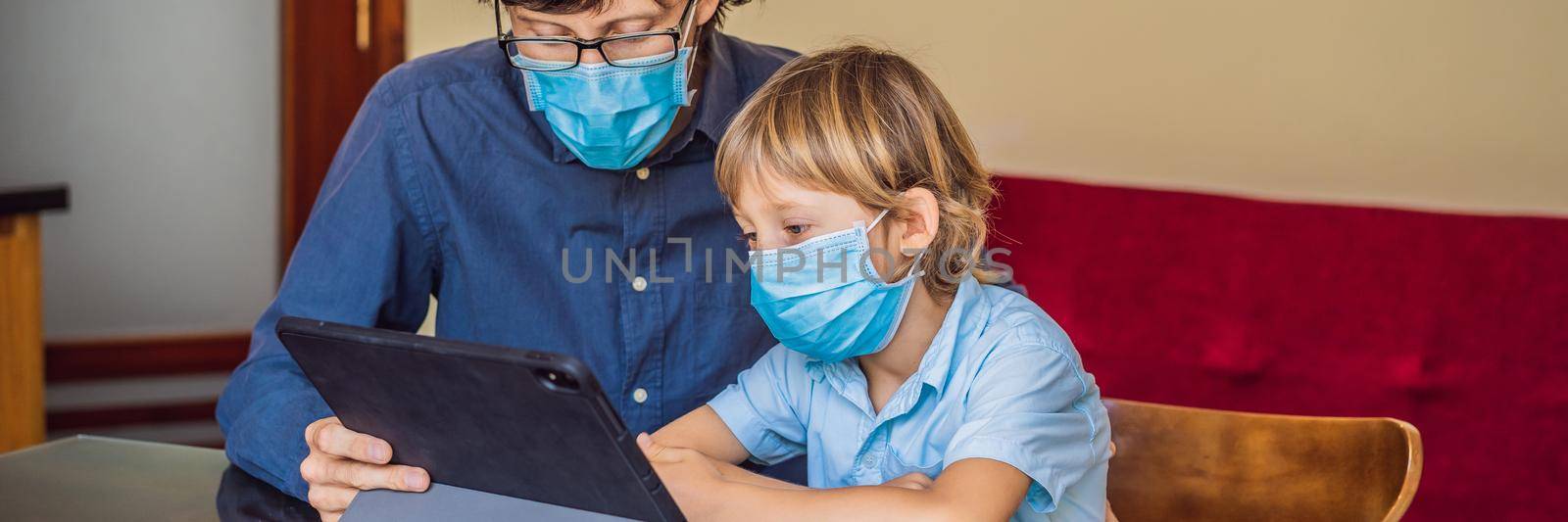 Boy studying online at home using a tablet. Father helps him learn. Father and son in medical masks to protect against coronovirus. Studying during quarantine. Global pandemic covid19 virus BANNER, LONG FORMAT by galitskaya