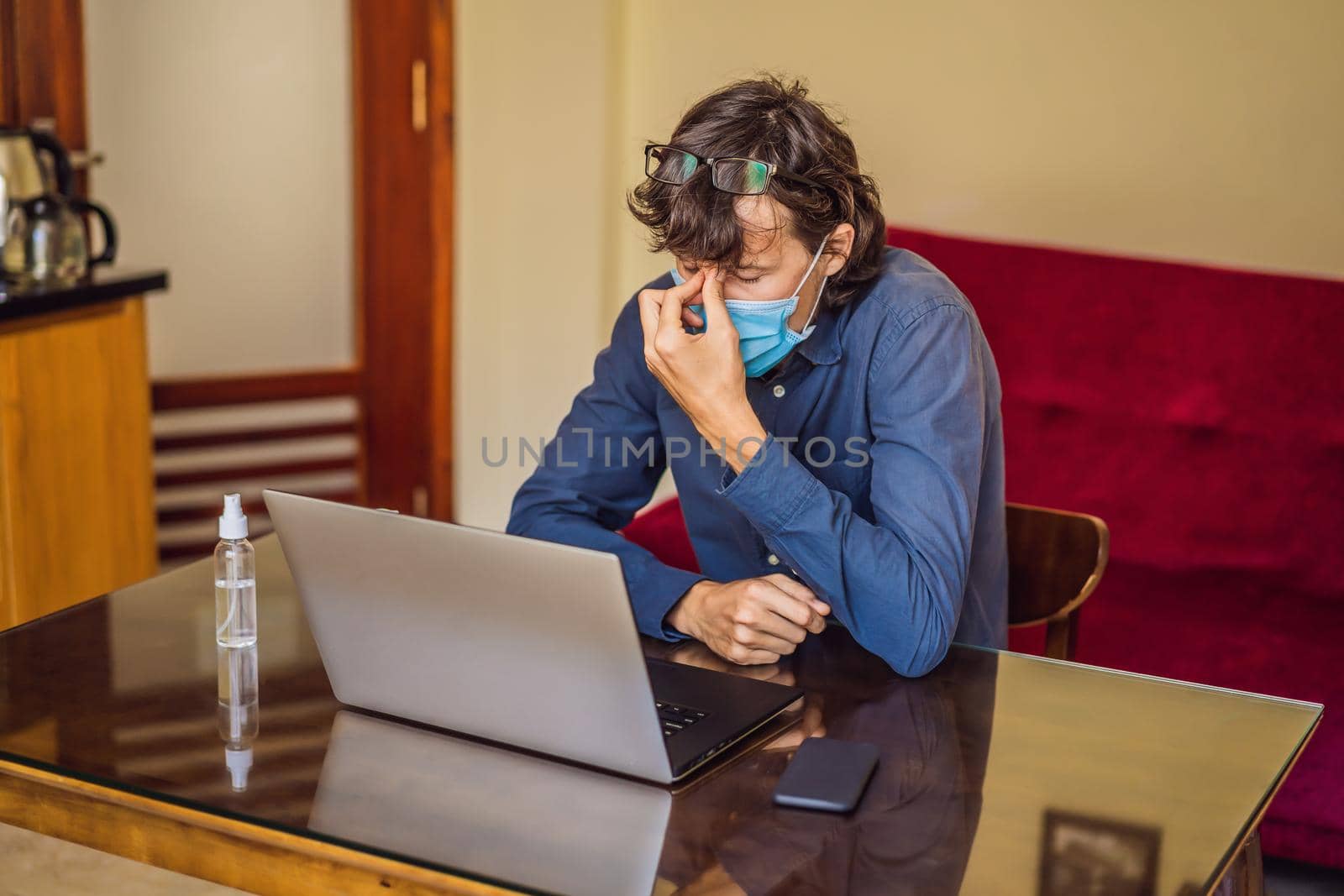 Coronavirus. Man working from home wearing protective mask. quarantine for coronavirus wearing protective mask. Working from home by galitskaya