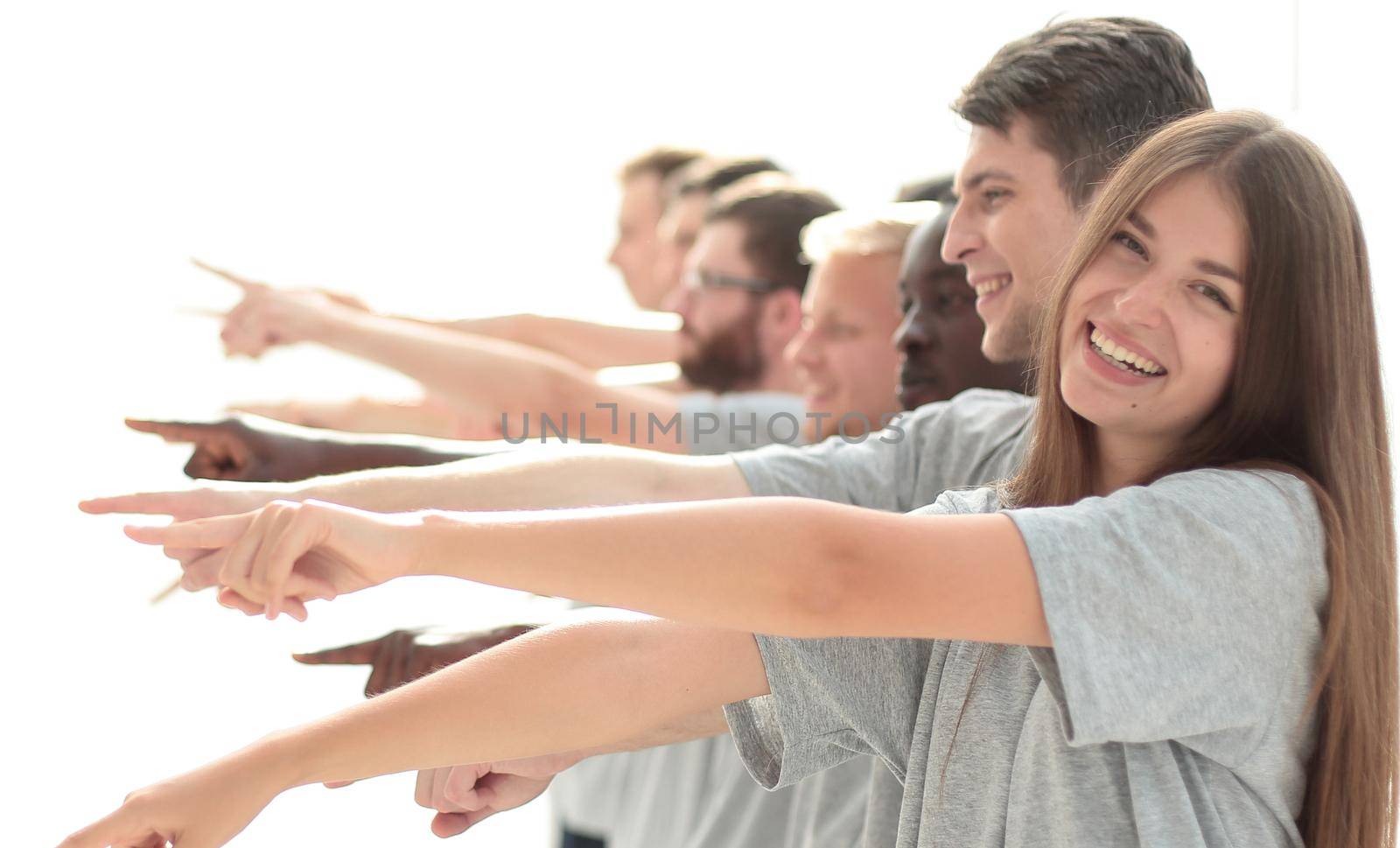 confident group of young men pointing ahead. by asdf