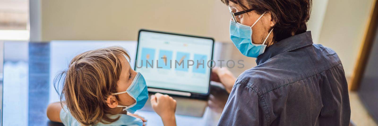 Boy studying online at home using a tablet. Father helps him learn. Father and son in medical masks to protect against coronovirus. Studying during quarantine. Global pandemic covid19 virus BANNER, LONG FORMAT by galitskaya