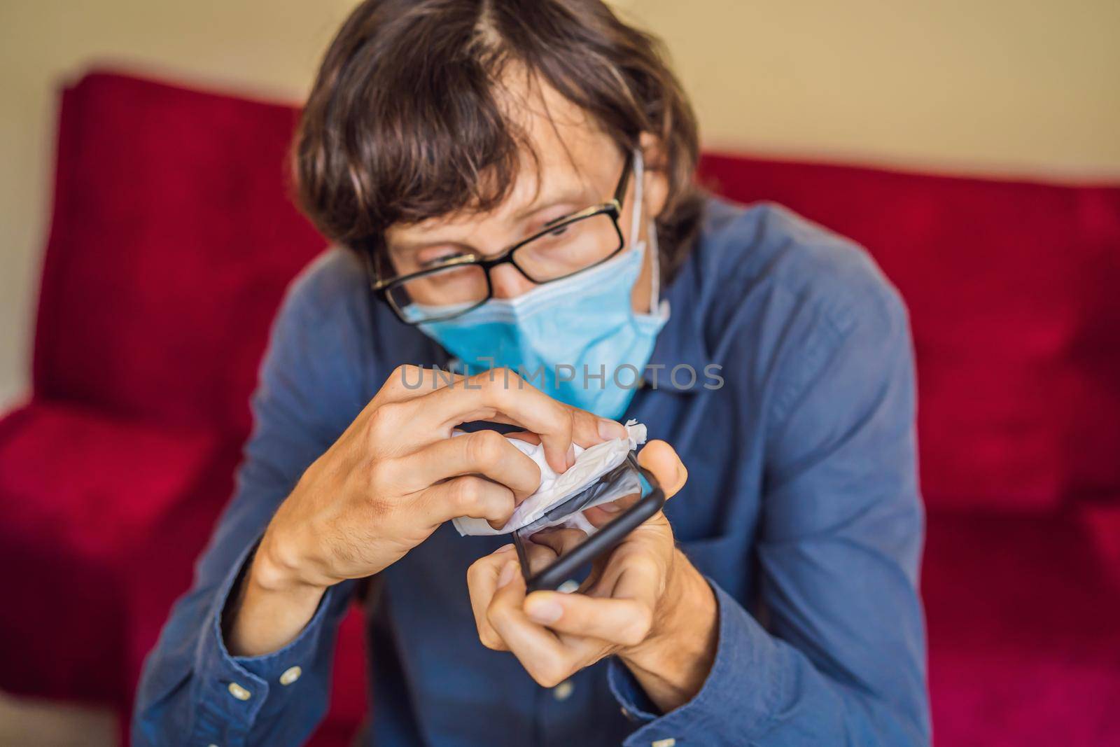 Man cleaning smartphone screen with alcohol or sanitizer. Concept of Cleaning dirty screen phone for disease prevention from bacteria. coronavirus covid 19.