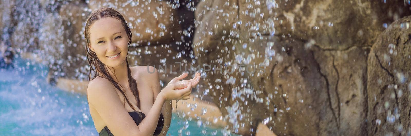 Young joyful woman under the water stream, pool, day spa, hot springs BANNER, LONG FORMAT by galitskaya