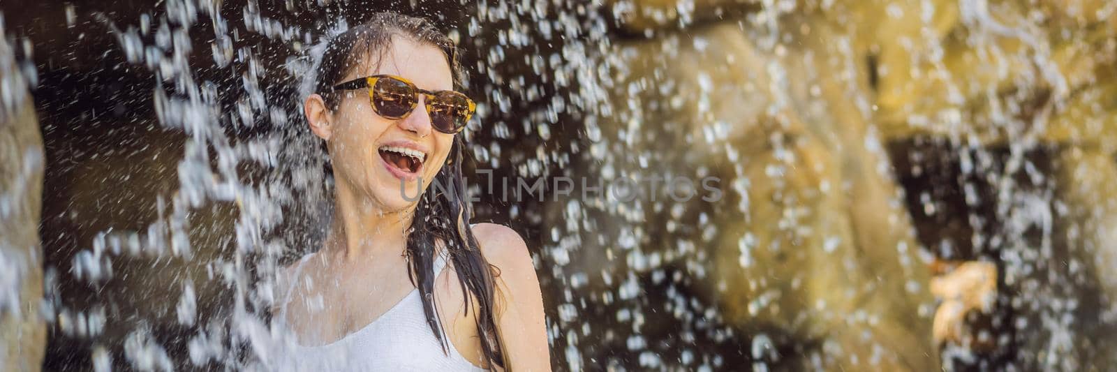 Young joyful woman under the water stream, pool, day spa, hot springs BANNER, LONG FORMAT by galitskaya
