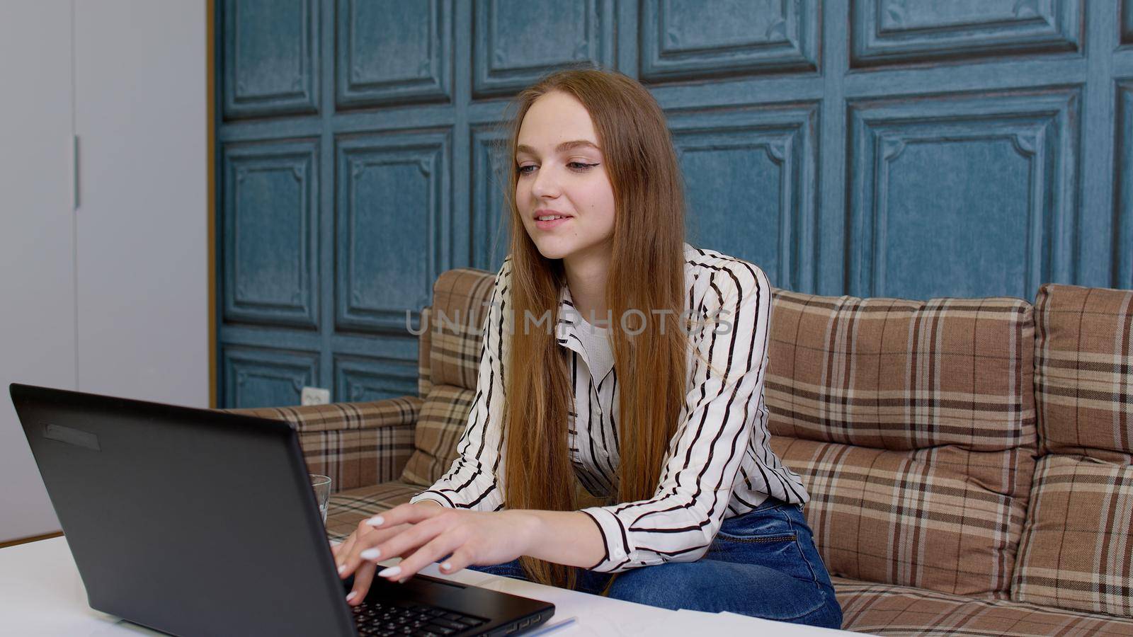 Joyful girl reading good news on pc laptop in slow motion. Portrait of happy business woman enjoy success shopping on computer at home office. Surprised lady celebrating lottery victory in living room