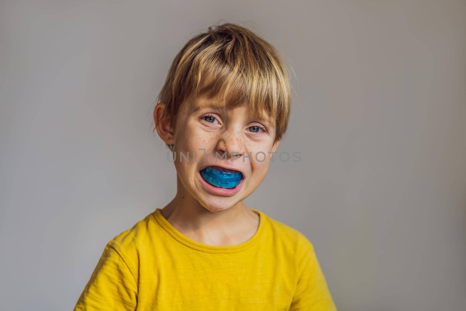 Six-year old boy shows myofunctional trainer. Helps equalize the growing teeth and correct bite, develop mouth breathing habit. Corrects the position of the tongue.